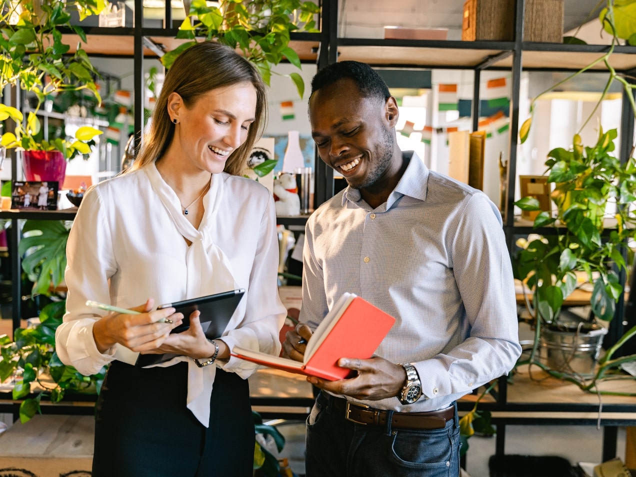 Two adults gather in workplace to review document together