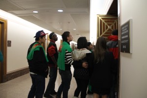 Students with Dignity in Schools t-shirts ushered into an 150-person overflow room, which would also fill up