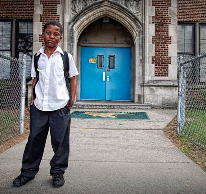 boy in front of school