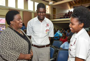 Chief Executive Officer of the Dispute Resolution Foundation (DRF), Donna Parchment Brown (left), engages in light discussion with Campion College students, Khadijah Chin (right) and Jordan Jarrett, at the Restorative Justice Facilitators graduation and awards ceremony held on Thursday, February 7, at the Edna Manley College of the Visual and Performing Arts in Kingston. Photo & caption from JIS.